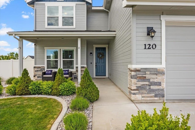 120 Pilgrim Way, Middleton, ID 83644 - doorway to property with covered porch, stone siding, a garage, and board and batten siding