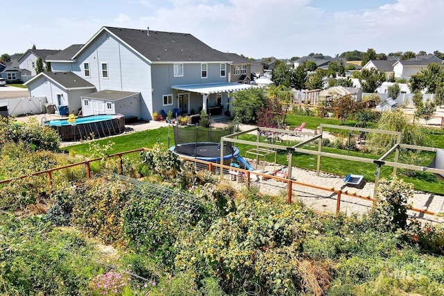 120 Pilgrim Way, Middleton, ID 83644 - back of property with a trampoline, a residential view, a patio, and a garage