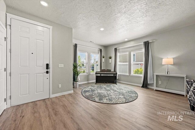 120 Pilgrim Way, Middleton, ID 83644 - foyer entrance with wood finished floors, a textured ceiling, baseboards, and recessed lighting