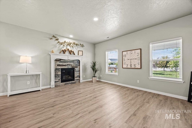 120 Pilgrim Way, Middleton, ID 83644 - unfurnished living room with a textured ceiling, wood finished floors, recessed lighting, a fireplace, and baseboards