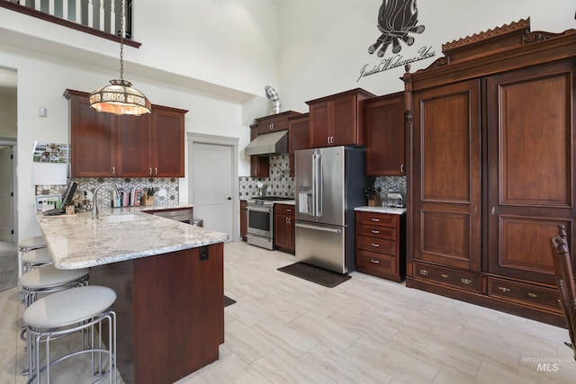 110 S 3rd Ave, Pierce, ID 83546 - kitchen featuring appliances with stainless steel finishes, extractor fan, a sink, a peninsula, and decorative backsplash