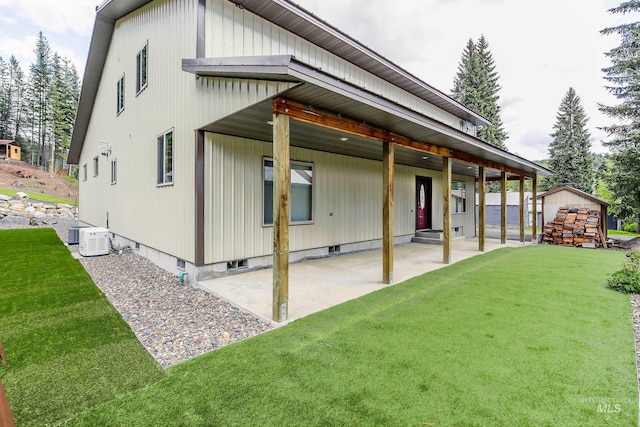 110 S 3rd Ave, Pierce, ID 83546 - back of property featuring a yard, a patio, an outbuilding, and central air condition unit