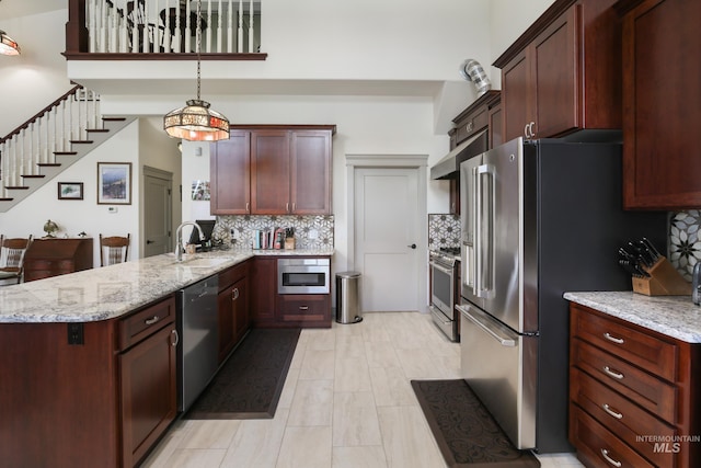 110 S 3rd Ave, Pierce, ID 83546 - kitchen featuring appliances with stainless steel finishes, a sink, a peninsula, tasteful backsplash, and a towering ceiling