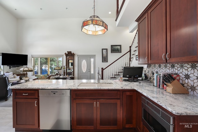 110 S 3rd Ave, Pierce, ID 83546 - kitchen with appliances with stainless steel finishes, a sink, a peninsula, a high ceiling, and open floor plan