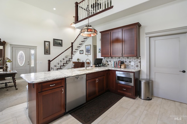 110 S 3rd Ave, Pierce, ID 83546 - kitchen with dishwashing machine, a peninsula, a towering ceiling, built in microwave, and light stone counters