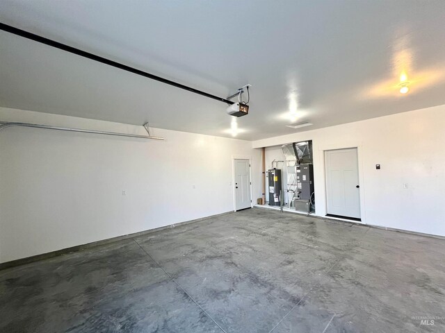 garage with heating unit, electric water heater, and a garage door opener