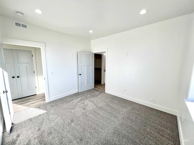 unfurnished bedroom featuring carpet, visible vents, baseboards, and recessed lighting