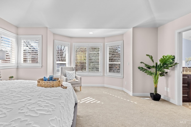 carpeted bedroom with baseboards and multiple windows