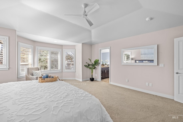 bedroom with a ceiling fan, baseboards, ensuite bath, lofted ceiling, and carpet flooring