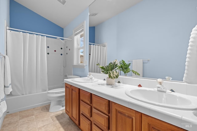 full bathroom with double vanity, toilet, shower / bath combo with shower curtain, and a sink