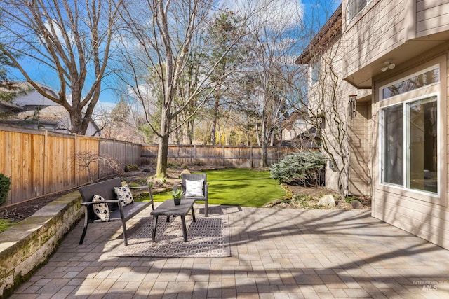 deck with a patio, a fenced backyard, and a lawn