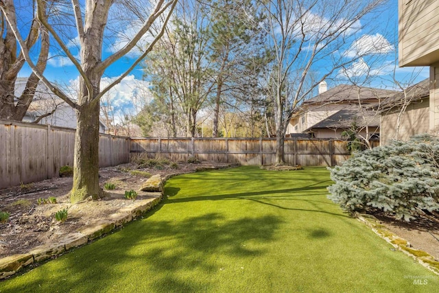 view of yard with a fenced backyard