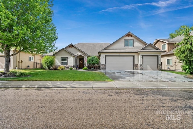 12231 W Caribee Inlet Dr, Star, ID 83669 - view of front facade with stone siding, a front lawn, driveway, and an attached garage