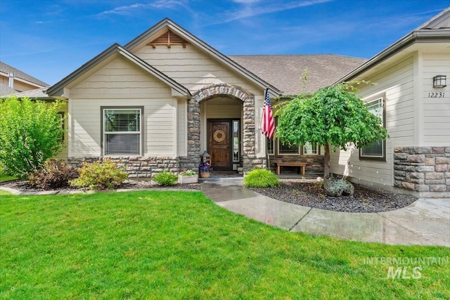 12231 W Caribee Inlet Dr, Star, ID 83669 - view of front facade featuring stone siding and a front lawn