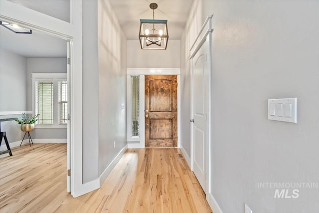 12231 W Caribee Inlet Dr, Star, ID 83669 - foyer featuring a chandelier and light wood-style flooring