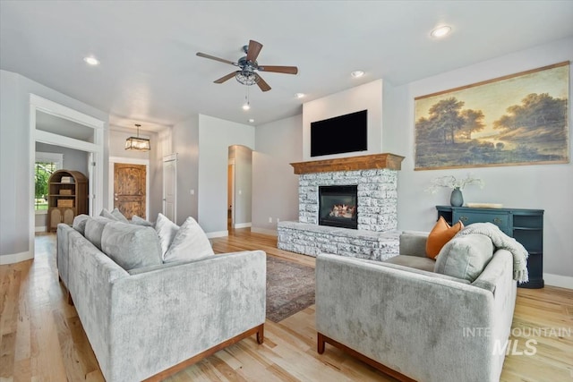 12231 W Caribee Inlet Dr, Star, ID 83669 - living area with a ceiling fan, a stone fireplace, recessed lighting, and wood finished floors
