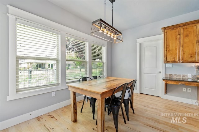 12231 W Caribee Inlet Dr, Star, ID 83669 - dining room with plenty of natural light, light wood-style floors, and a chandelier