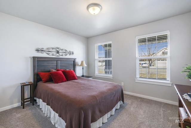 bedroom with baseboards, multiple windows, and carpet flooring