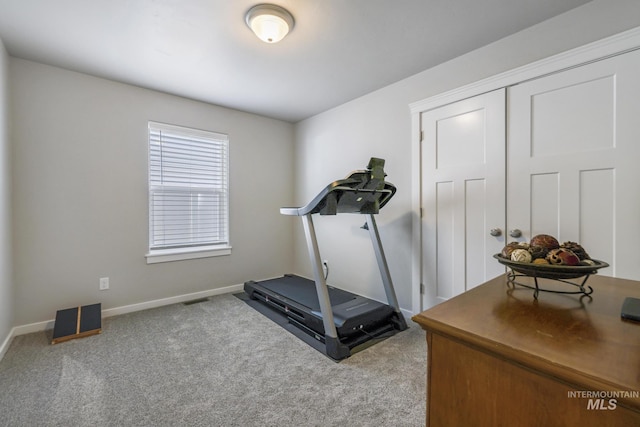 exercise area featuring visible vents, carpet floors, and baseboards