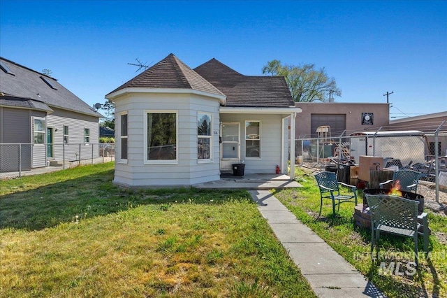 816 Denver St, Caldwell, ID 83605 - back of house featuring a fire pit and roof with shingles