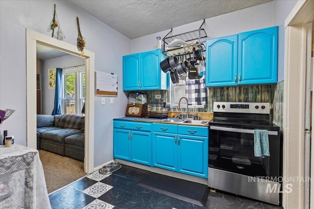 816 Denver St, Caldwell, ID 83605 - kitchen featuring stainless steel range with electric stovetop, a sink, blue cabinets, dark floors, and a textured ceiling