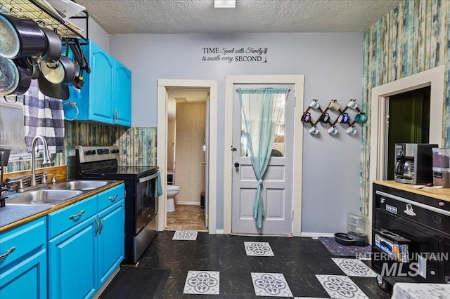 816 Denver St, Caldwell, ID 83605 - kitchen with stainless steel range with electric stovetop, a sink, a textured ceiling, blue cabinets, and dark flooring