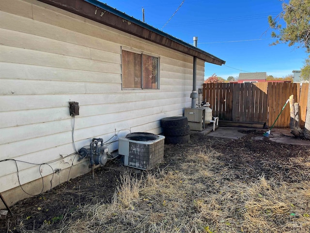 view of side of property with central air condition unit