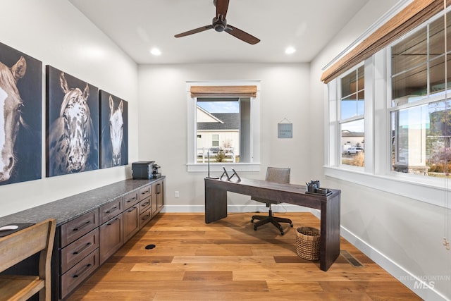 office space with a ceiling fan, visible vents, baseboards, light wood-style flooring, and recessed lighting