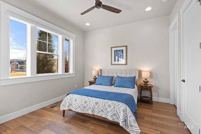 bedroom with recessed lighting, baseboards, wood finished floors, and ceiling fan