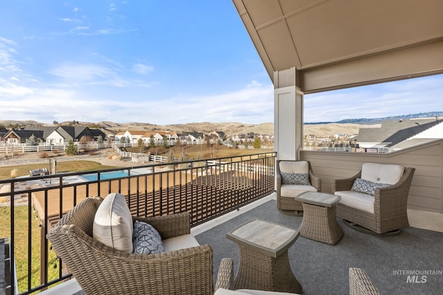 balcony featuring a mountain view and a residential view