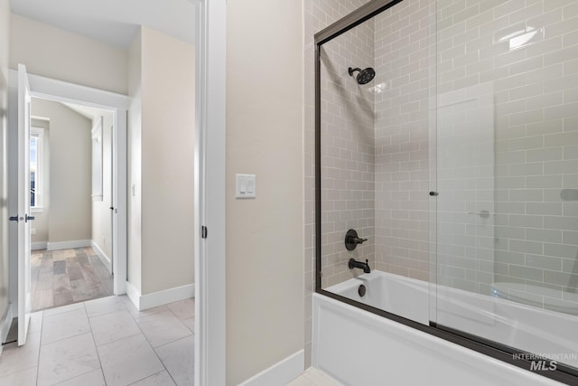 full bath with tile patterned flooring, baseboards, and enclosed tub / shower combo