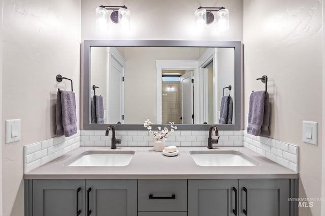 full bathroom with double vanity, tasteful backsplash, and a sink