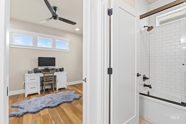 home office featuring light wood finished floors, baseboards, and ceiling fan