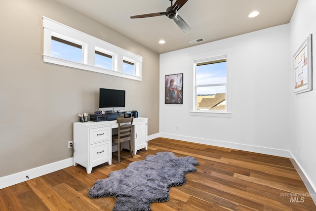 office space featuring visible vents, baseboards, a ceiling fan, and wood finished floors