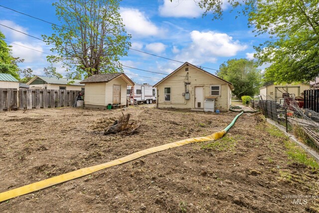 328 W Owyhee Ave, Homedale, ID 83628 - rear view of property featuring a fenced backyard, a storage shed, and an outbuilding