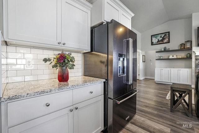 kitchen with high end fridge, dark wood-type flooring, backsplash, vaulted ceiling, and white cabinetry