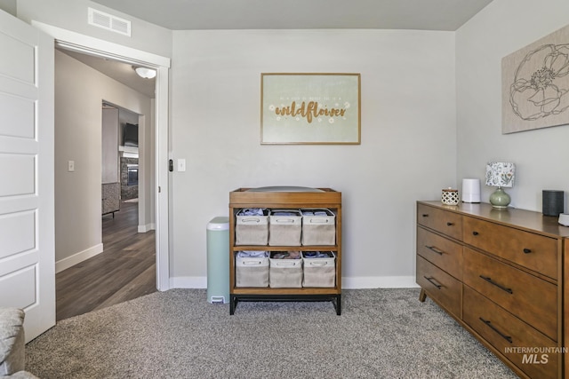 interior space with visible vents, carpet flooring, and baseboards