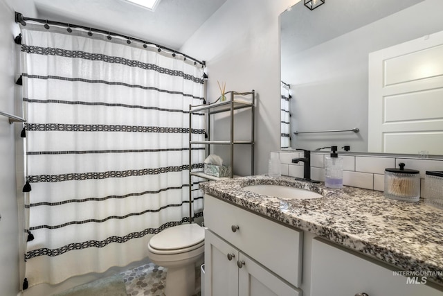 bathroom with toilet, curtained shower, backsplash, and vanity