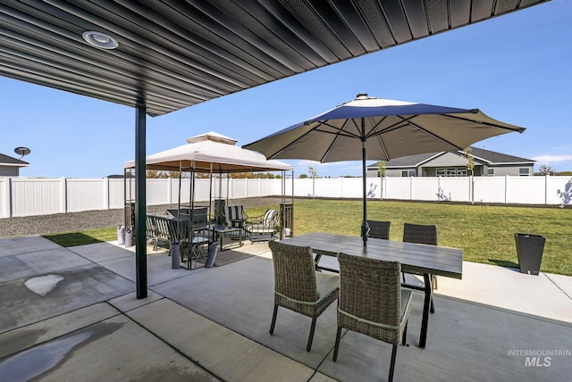 view of patio with a gazebo, a fenced backyard, and outdoor dining area