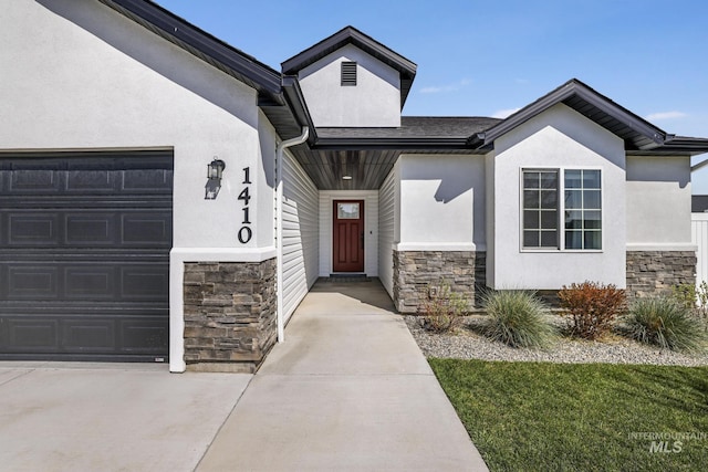 view of exterior entry with stucco siding and stone siding