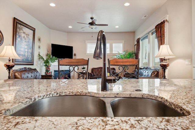 11771 W Cross Slope Way, Nampa, ID 83686 - kitchen with recessed lighting, ceiling fan, light stone counters, and a wealth of natural light