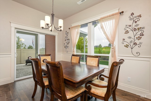 11771 W Cross Slope Way, Nampa, ID 83686 - dining area featuring visible vents, dark wood-type flooring, a decorative wall, a notable chandelier, and wainscoting