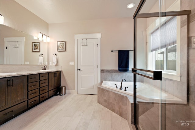 11771 W Cross Slope Way, Nampa, ID 83686 - bathroom with baseboards, a garden tub, double vanity, and a sink