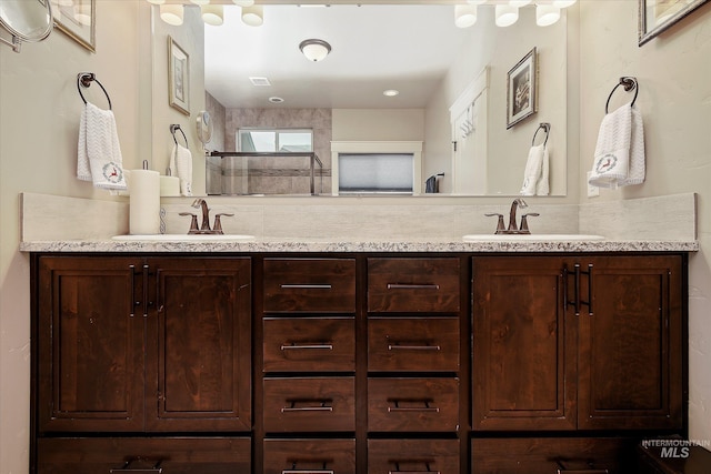 11771 W Cross Slope Way, Nampa, ID 83686 - bathroom with a tile shower, double vanity, and a sink
