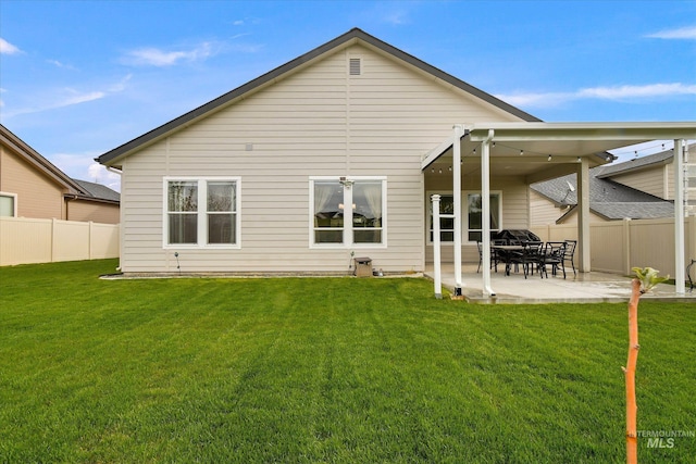 11771 W Cross Slope Way, Nampa, ID 83686 - rear view of house with a yard, a patio area, and fence