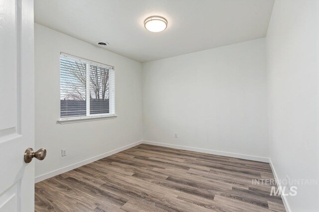 spare room featuring hardwood / wood-style flooring