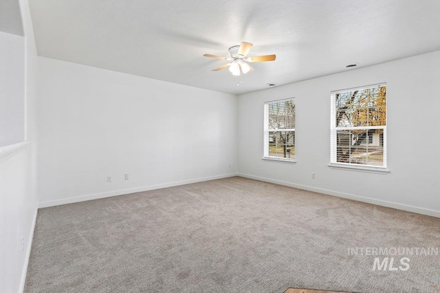 carpeted empty room featuring ceiling fan