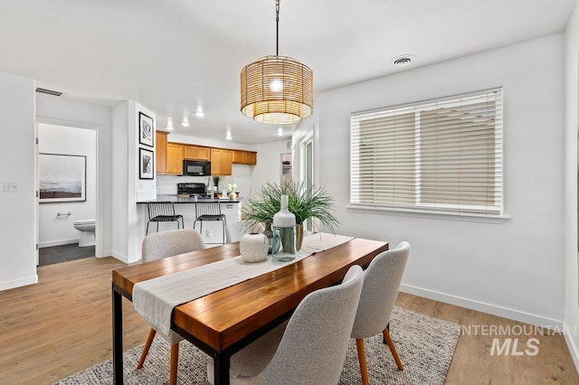 178 W Lava Falls Dr, Meridian, ID 83646 - dining space with baseboards and light wood-style flooring