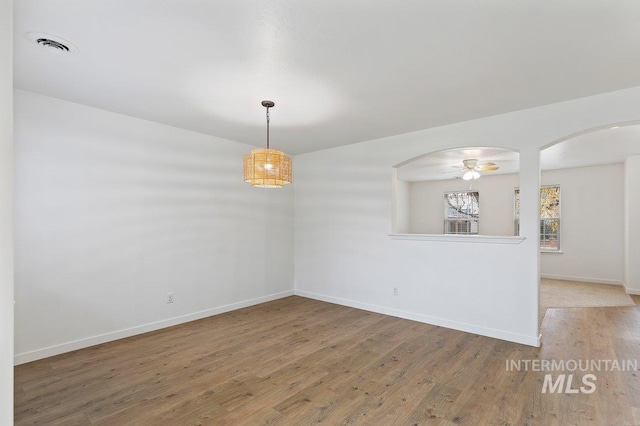 empty room featuring hardwood / wood-style floors and ceiling fan