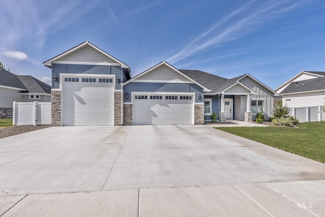 craftsman inspired home featuring a garage, stone siding, and concrete driveway